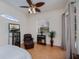 Bedroom with mirrored furniture, ceiling fan, and a private exterior door at 4308 Via Del Santi, Venice, FL 34293
