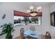 Breakfast nook with a glass table and chairs overlooking the pool and pond at 4308 Via Del Santi, Venice, FL 34293