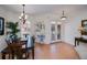 Elegant dining space with a wooden table, decorative lighting, and beautiful entryway at 4308 Via Del Santi, Venice, FL 34293