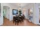 Charming dining area showcasing a wooden table, chandelier, and bright window views at 4308 Via Del Santi, Venice, FL 34293
