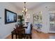 Formal dining area with a wooden table, stylish chairs, and bright natural light at 4308 Via Del Santi, Venice, FL 34293