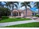 Lovely home with well-manicured lawn and mature palm trees enhancing curb appeal at 4308 Via Del Santi, Venice, FL 34293