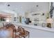 Open-concept kitchen featuring white cabinets, breakfast bar and stainless steel appliances at 4308 Via Del Santi, Venice, FL 34293