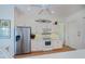 Bright kitchen with white cabinets, stainless steel appliances, and breakfast bar seating at 4308 Via Del Santi, Venice, FL 34293