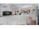 Open-concept kitchen with white cabinets, breakfast bar, and views of the living area at 4308 Via Del Santi, Venice, FL 34293