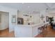 Open-concept kitchen boasting white cabinets, stainless steel appliances, and a spacious breakfast bar at 4308 Via Del Santi, Venice, FL 34293