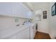 This laundry room has lots of cabinet storage, a utility sink and a washer/dryer at 4308 Via Del Santi, Venice, FL 34293