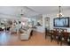 Bright living room featuring tile floors, an open floor plan, and a breakfast bar at 4308 Via Del Santi, Venice, FL 34293