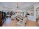 Comfortable living room showcasing tile floors, a ceiling fan, and access to the lanai at 4308 Via Del Santi, Venice, FL 34293