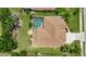 Aerial view of the property featuring a screened pool, well-maintained landscaping, and a tile roof at 435 Boundary Blvd, Rotonda West, FL 33947