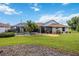 Spacious backyard featuring a screened pool, lanai, patio area, and lush green grass at 435 Boundary Blvd, Rotonda West, FL 33947
