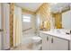 Neutral bathroom with shower-tub, white vanity, tiled floors and decorative wall paper at 435 Boundary Blvd, Rotonda West, FL 33947