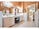Spacious bathroom with double vanity, stylish wallpaper, and access to the living area at 435 Boundary Blvd, Rotonda West, FL 33947