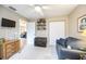 Bedroom with comfortable seating, ceiling fan, and a view into the living area at 435 Boundary Blvd, Rotonda West, FL 33947