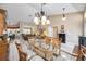 Inviting dining area with a glass table, rattan chairs, and elegant chandelier at 435 Boundary Blvd, Rotonda West, FL 33947