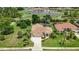 Charming single-story home with a lush green lawn, mature trees, and colorful flower beds at 435 Boundary Blvd, Rotonda West, FL 33947