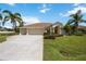 Charming single-story home with a two-car garage and lush landscaping at 435 Boundary Blvd, Rotonda West, FL 33947