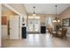 Bright foyer with tile floors, decorative lighting, double front doors, and a view into the dining area at 435 Boundary Blvd, Rotonda West, FL 33947