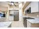 Open kitchen with white cabinets, stainless steel appliances, and marbled countertops at 435 Boundary Blvd, Rotonda West, FL 33947
