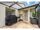 Outdoor lanai with a built-in counter, sink, grill, and access door to the house at 435 Boundary Blvd, Rotonda West, FL 33947