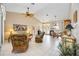 Spacious living room with high ceilings, tile flooring, and comfortable rattan furniture at 435 Boundary Blvd, Rotonda West, FL 33947