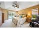 Serene main bedroom with pool access, ceiling fan, and plenty of natural light at 435 Boundary Blvd, Rotonda West, FL 33947