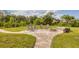 Backyard patio with beautiful pavers, a fire pit, seating, and a swing set at 458 Ceil Ct, Nokomis, FL 34275
