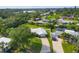 Beautiful home with a metal roof, a long driveway, mature trees, and a lush, green lawn at 458 Ceil Ct, Nokomis, FL 34275