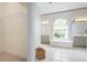 Bright bathroom with a garden tub under a large window and dual vanities with decorative lighting at 467 Sherbrooke Ct, Venice, FL 34293