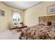 Inviting bedroom with natural light and a cozy seating area featuring a couch and stylish coffee table at 467 Sherbrooke Ct, Venice, FL 34293