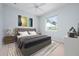 Bedroom featuring a bed, nightstands, and a window overlooking the yard at 467 Sherbrooke Ct, Venice, FL 34293