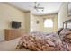 Bright bedroom features neutral walls, plush carpeting, ceiling fan and sliding glass doors to outside at 467 Sherbrooke Ct, Venice, FL 34293