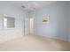 Bright bedroom with neutral carpet and open doorway at 467 Sherbrooke Ct, Venice, FL 34293