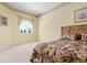 Comfortable bedroom with neutral carpet, large window, and decorative wallpaper accents at 467 Sherbrooke Ct, Venice, FL 34293