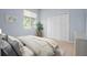 Comfortable bedroom with blue walls, a double closet, and a view of the green backyard at 467 Sherbrooke Ct, Venice, FL 34293