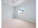 Bedroom featuring neutral carpet and a window overlooking the yard at 467 Sherbrooke Ct, Venice, FL 34293