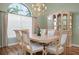 Formal dining room showcasing a chandelier, large window, and elegant china cabinet at 467 Sherbrooke Ct, Venice, FL 34293
