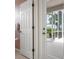 A white interior door leading to a screened outdoor space with a garden view at 467 Sherbrooke Ct, Venice, FL 34293
