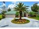 An exterior view of a home with a circular driveway and a large palm tree in the center and a teal roof at 467 Sherbrooke Ct, Venice, FL 34293