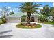 Beautiful single-story home featuring a circular driveway, well-manicured landscaping, and a tile roof at 467 Sherbrooke Ct, Venice, FL 34293