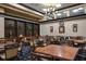 Well-appointed game room with multiple tables, comfortable chairs, a cozy chandelier, and attractive decor for entertaining guests at 467 Sherbrooke Ct, Venice, FL 34293