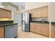 Spacious kitchen featuring stainless steel refrigerator and ample cabinetry at 467 Sherbrooke Ct, Venice, FL 34293