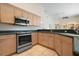Well-equipped kitchen with stainless steel range and plenty of cabinet storage at 467 Sherbrooke Ct, Venice, FL 34293