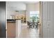 Breakfast nook with a round table set adjacent to the kitchen at 467 Sherbrooke Ct, Venice, FL 34293