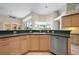 Functional kitchen design with green countertops and stainless steel dishwasher at 467 Sherbrooke Ct, Venice, FL 34293