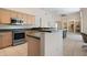 Open-concept kitchen with stainless steel appliances and ample counter space at 467 Sherbrooke Ct, Venice, FL 34293