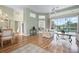 Open-concept living room with wood floors, seamless access to the dining area, and serene pool views at 467 Sherbrooke Ct, Venice, FL 34293