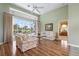 Bright living room featuring wood floors, a ceiling fan, and sliding glass doors to the pool at 467 Sherbrooke Ct, Venice, FL 34293