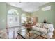 Bright living area featuring large windows, tile floors, and floral patterned sofas at 467 Sherbrooke Ct, Venice, FL 34293