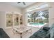 Bright living room featuring tile floors and a large glass sliding door with access to a pool at 467 Sherbrooke Ct, Venice, FL 34293